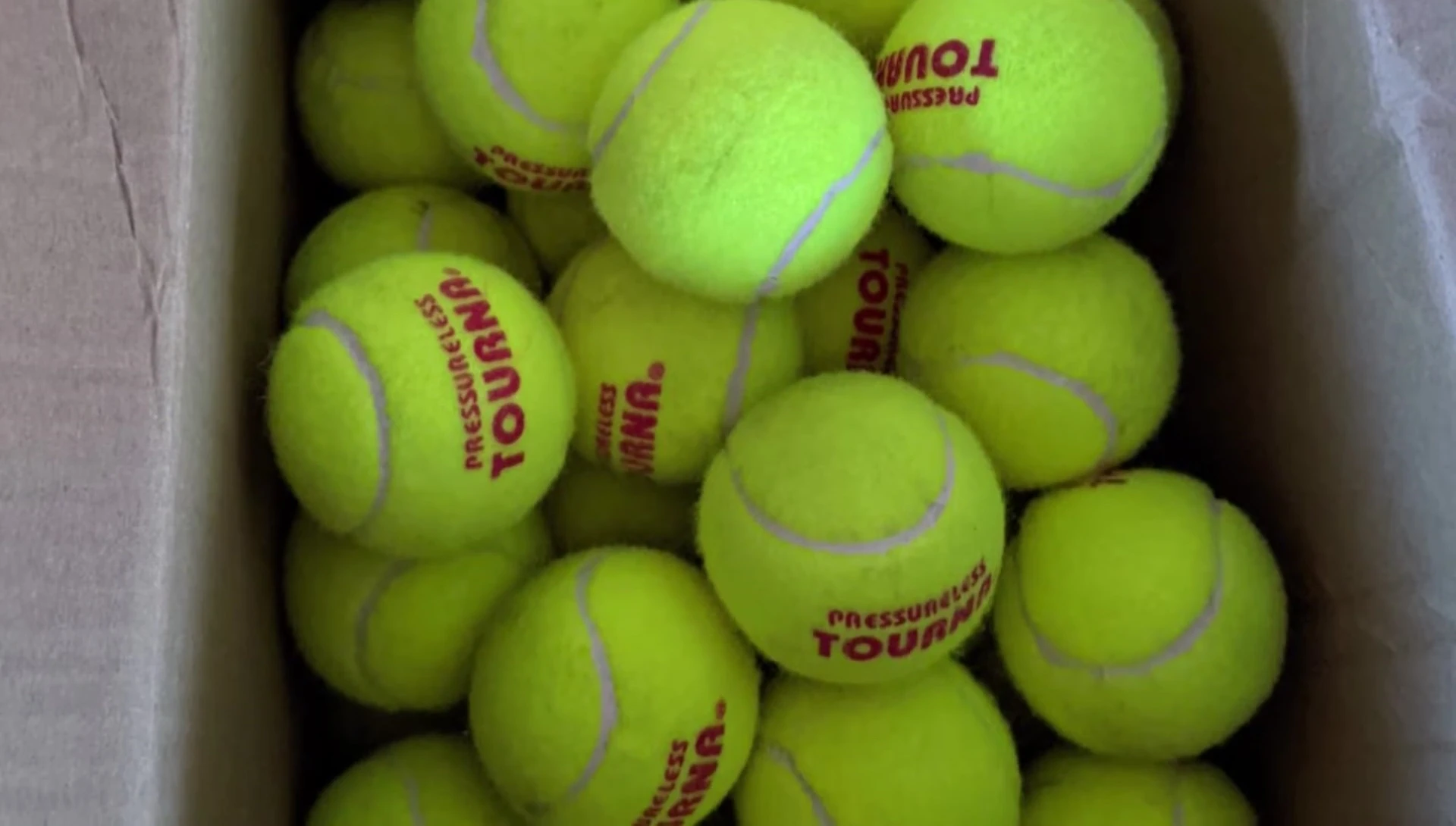 Tourna tennis balls in use with a ball machine