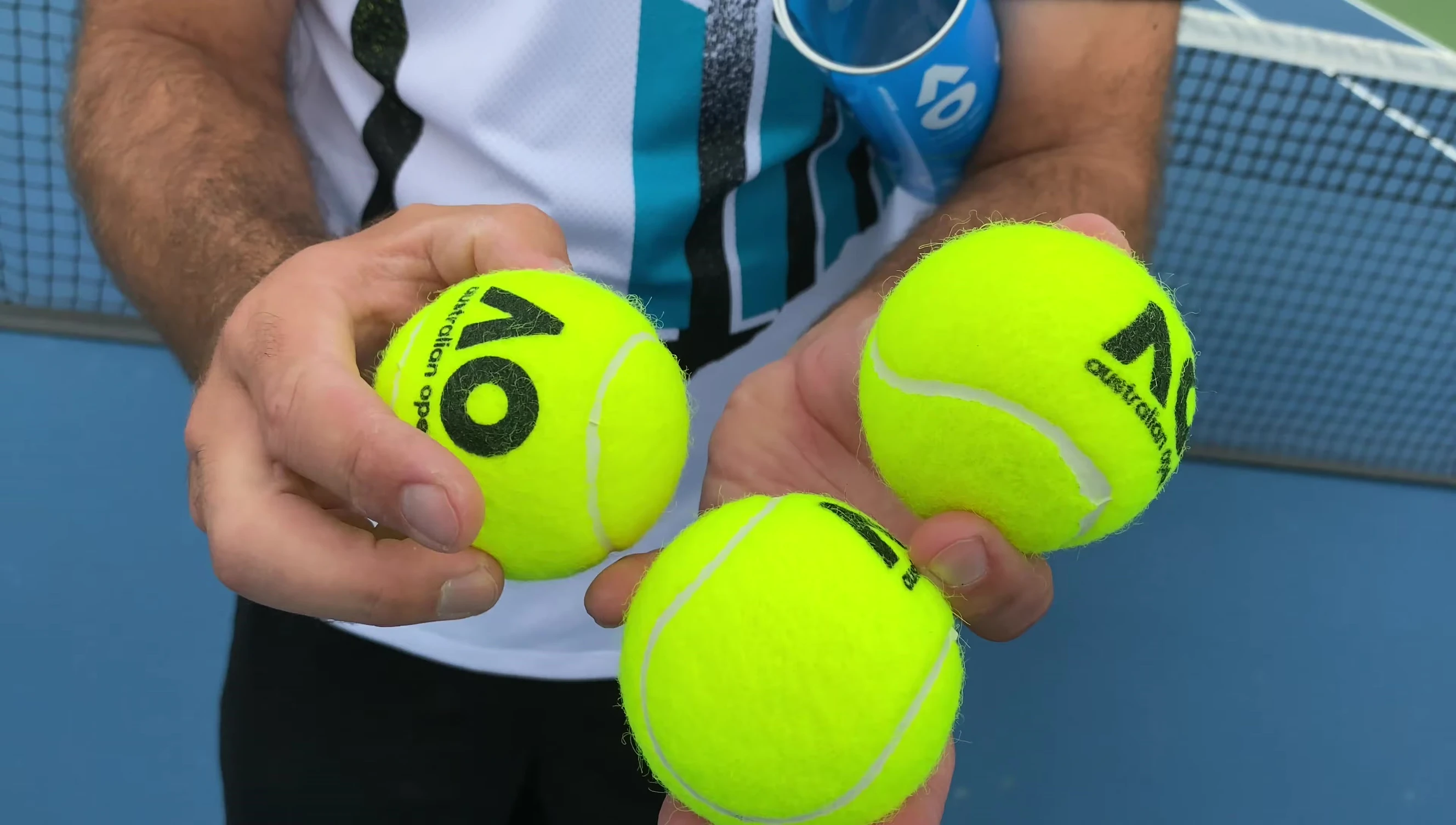 Hand squeezing an Australian Open tennis ball
