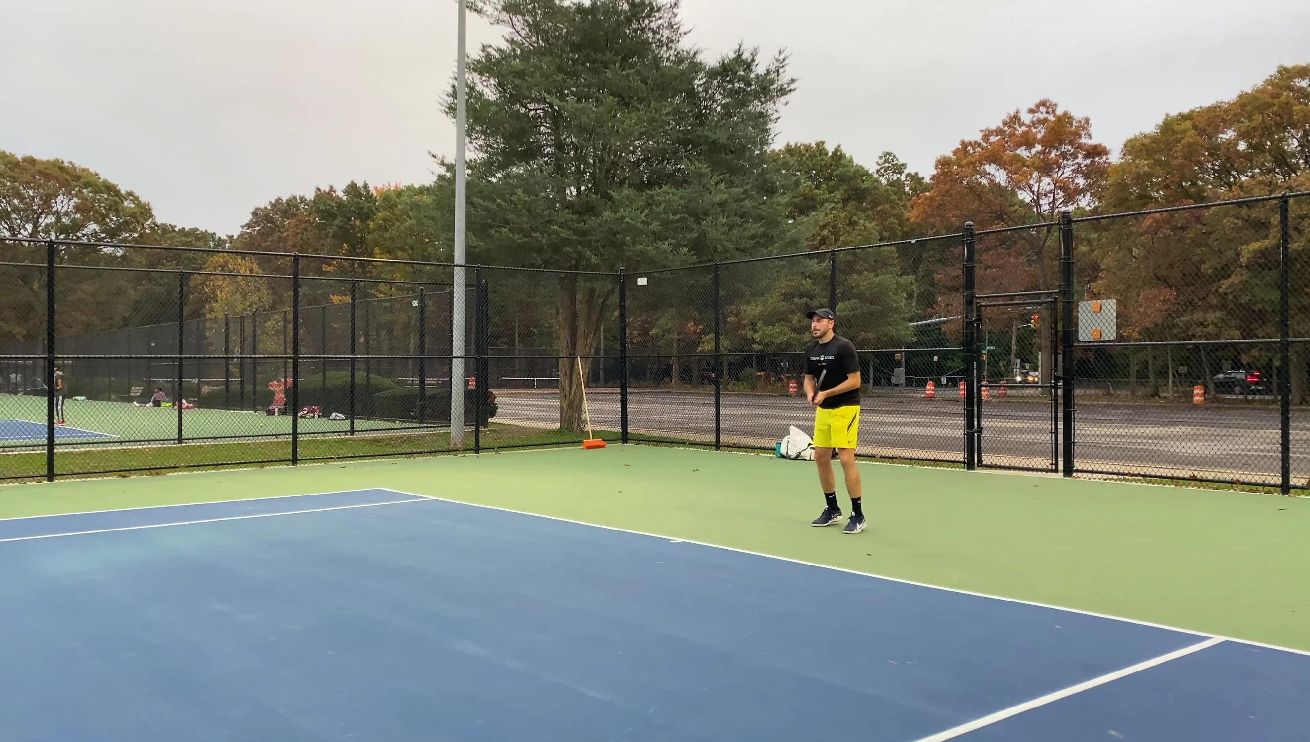Player hitting a tennis ball, showcasing its bounce.