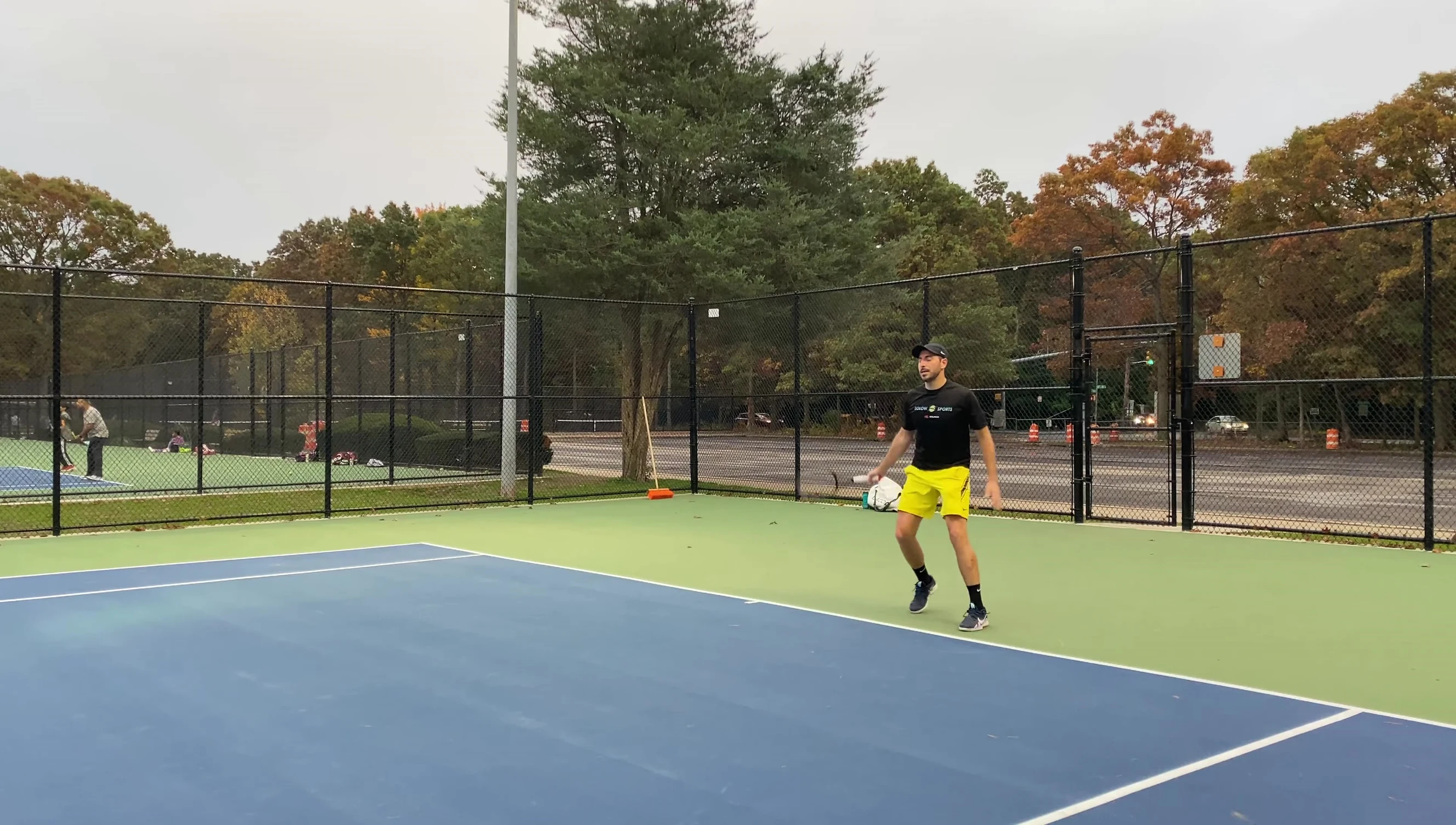 Hand squeezing a tennis ball to show consistency.