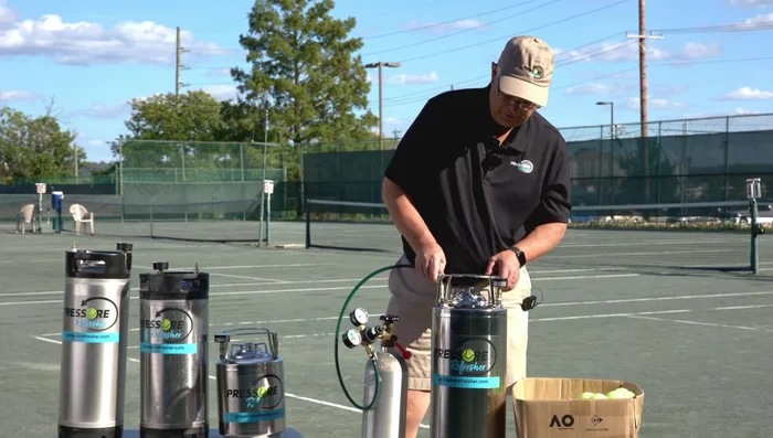 Pressurize: Connect the Pressure Refresher to a regulator set at 50 PSI. Pressurize up to 25-30 PSI (you'll hear the balls moving). Continue to 40 PSI.