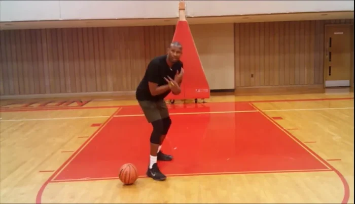 Get into an athletic stance, low to the ground with your shoulders aligned to your defender's waist.