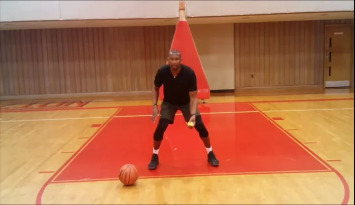 Repeat the toss and snatch 10 times on each side, focusing on keeping your palm to the ground when catching the ball to maintain a low center of gravity and evade defenders.