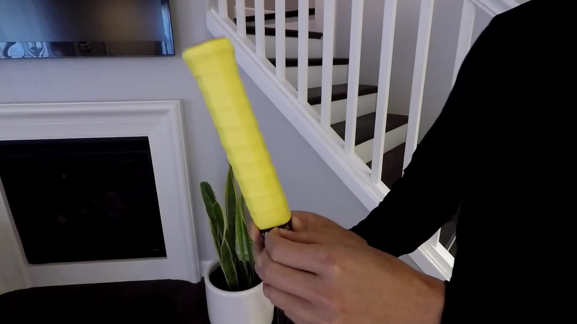 Unwinding the old overgrip from the throat of the racket