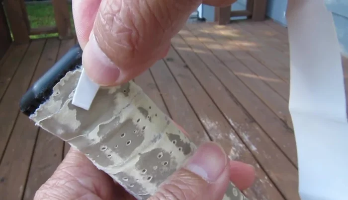 Begin wrapping the overgrip counter-clockwise around the handle, maintaining constant tension and slightly stretching the material.