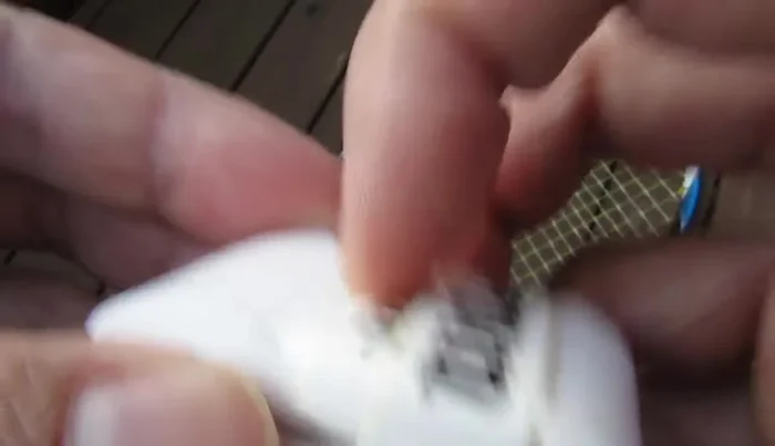 Peel off the protective plastic layer from the sticky end of the overgrip.