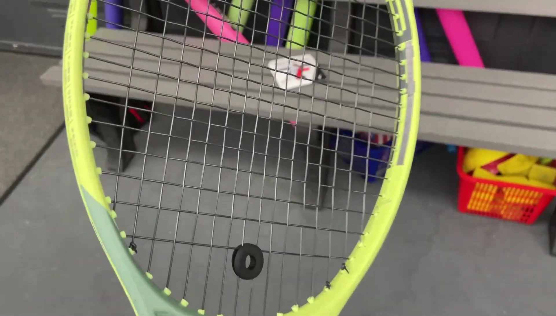 The racket with Razor Soft string, showing the tension.