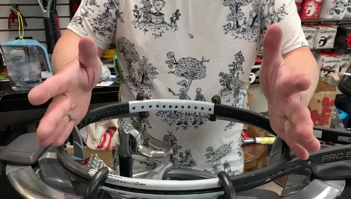 Tighten the 12 o'clock and 6 o'clock clamps securely, preventing racquet movement.