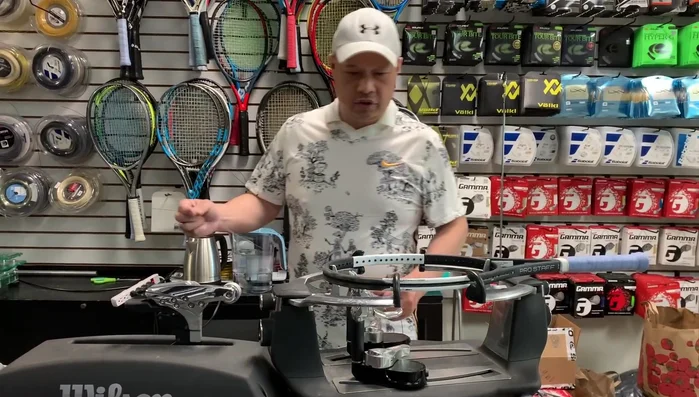 Measure and cut the main strings. The method shown involves measuring from the outer edge of the frame to the outer edge, repeating for the required number of mains on each side.