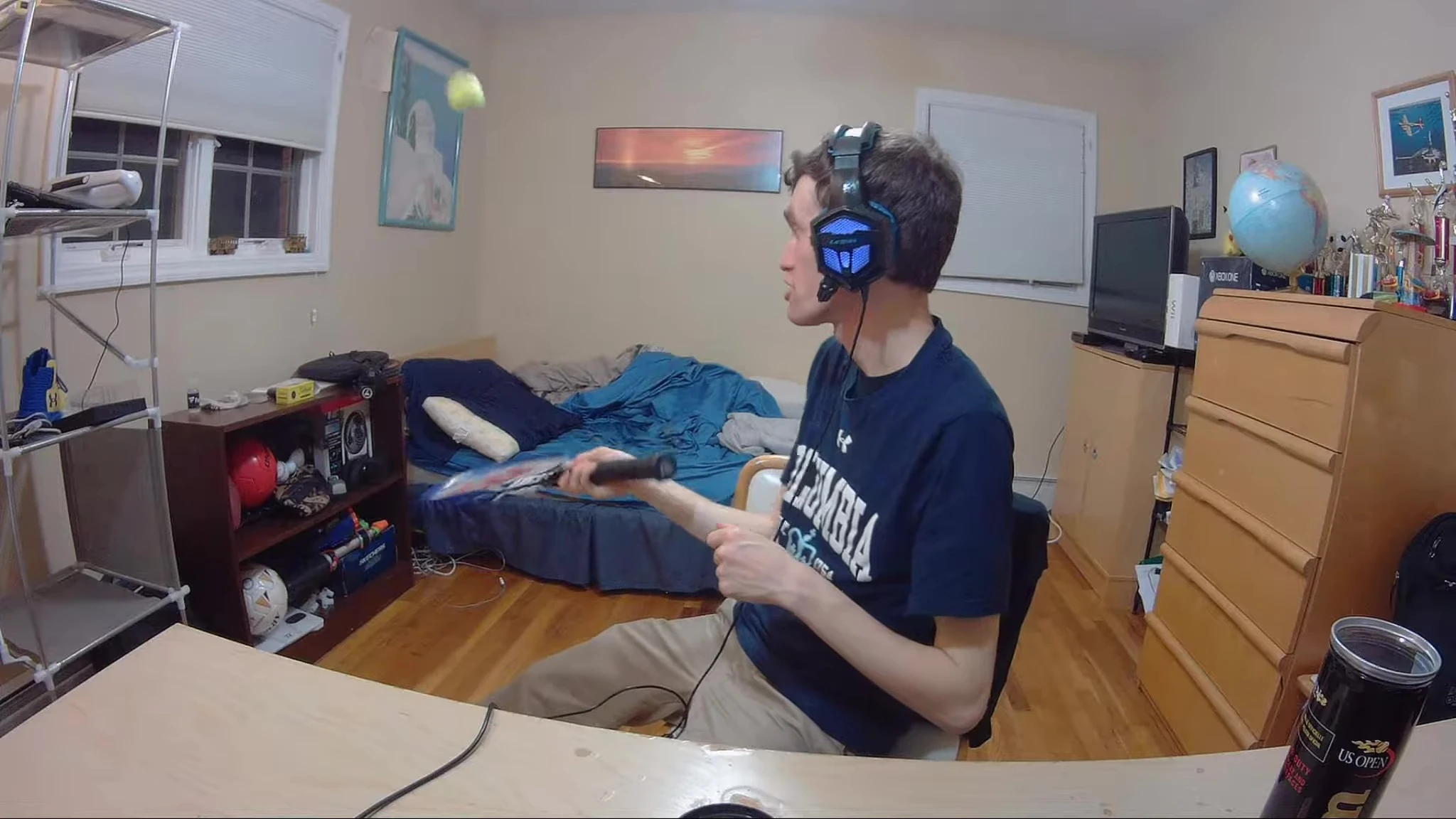 The reviewer bouncing a Wilson tennis ball.