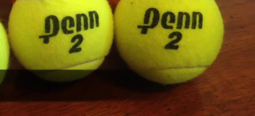 Final comparison shot of both orange and yellow tennis balls