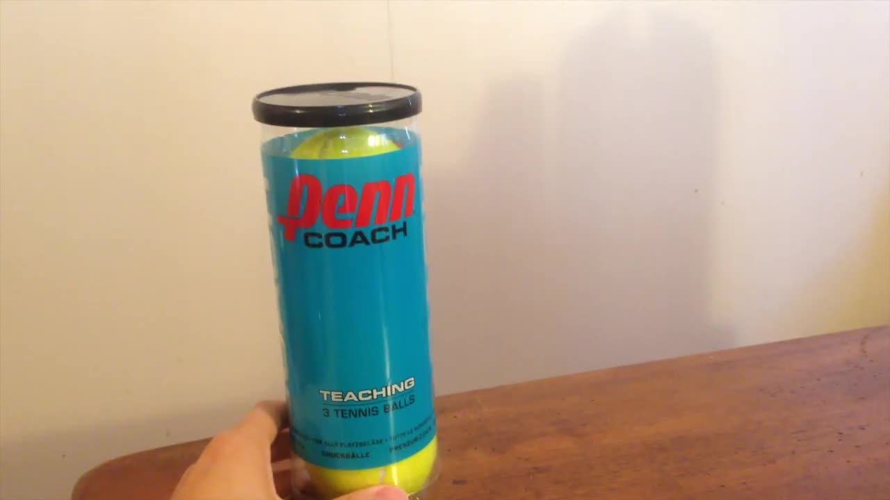 Close-up shot of the Penn Coach tennis ball packaging.