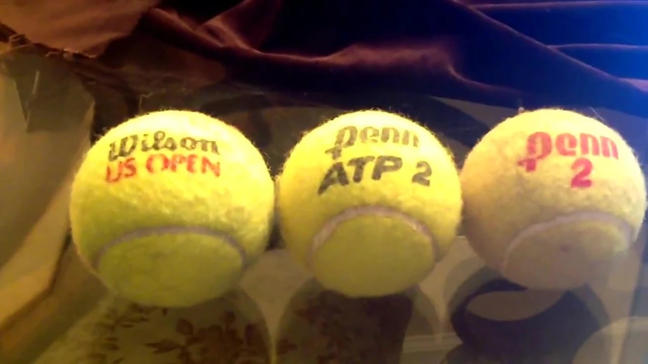 Speaker pointing at different tennis balls during the comparison