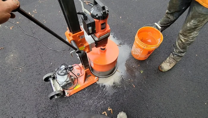 Mix concrete. Add water gradually to keep the drum cool and prevent concrete dust from contaminating the post sleeves.