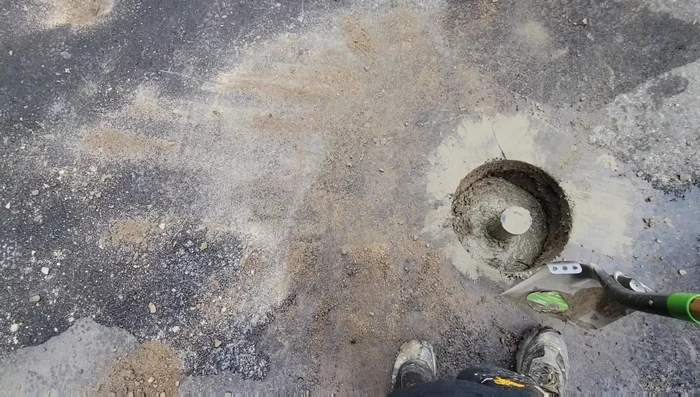 Let the concrete harden. Once the concrete develops some strength, come back to level and add gravel and asphalt to the top.