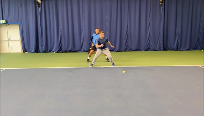 Player picks up the ball and returns to starting position quickly.