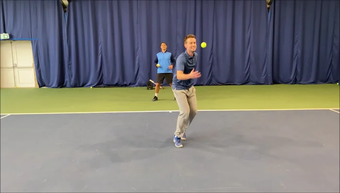 Player catches the ball before it bounces.