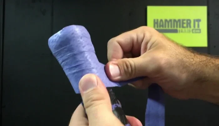 Overlap the grip by about an eighth of an inch with each turn, maintaining steady pressure.