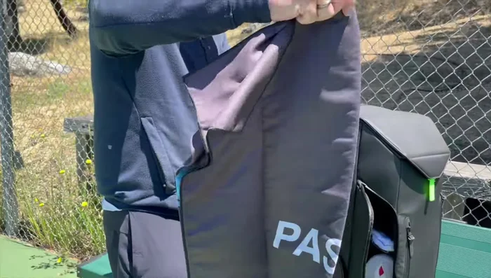 Demonstrating the shoe compartment and adjustable shelving.