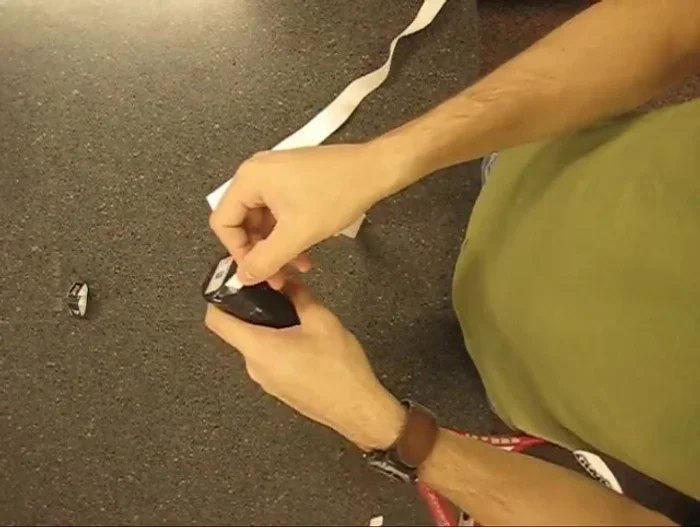 Start at the butt cap: Align the overgrip flush with the bottom of the butt cap, applying slight pressure to prevent bubbles.