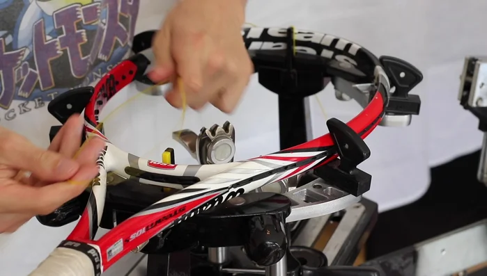 Determine the starting point for your first loop based on the number of grommets (3 or 4) at the racket end.