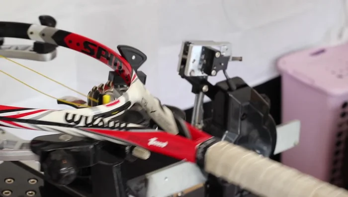 Apply initial tension using the stringing machine (adjust tension as needed). Clamp the opposite end after pulling the string tight.