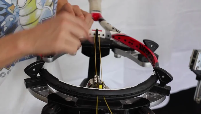 Continue stringing the mains, working outwards from the center, one or two at a time, tightening each string as you go.