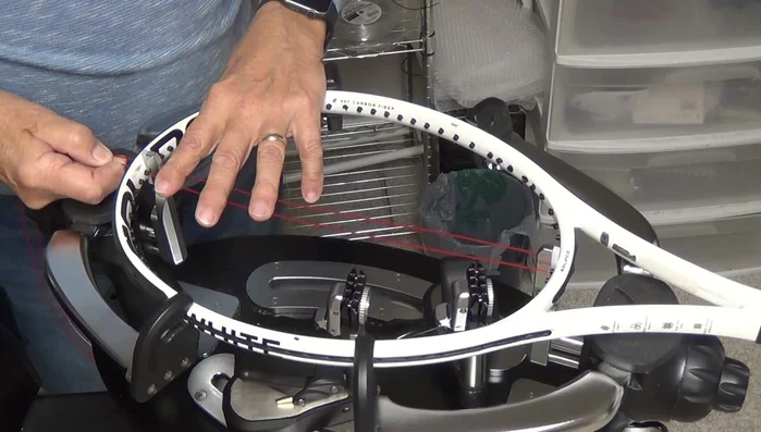 Remove the bulge on the outside of the string channel by pulling tension on the string.