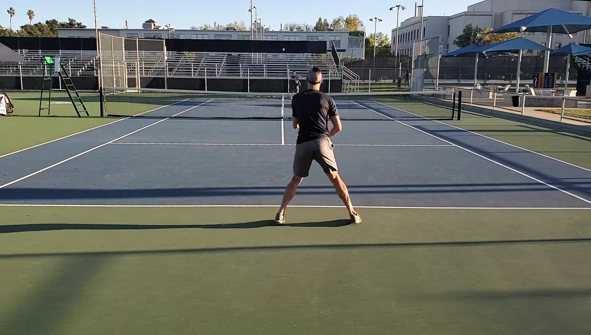 The reviewer hitting a forehand with the modified racket