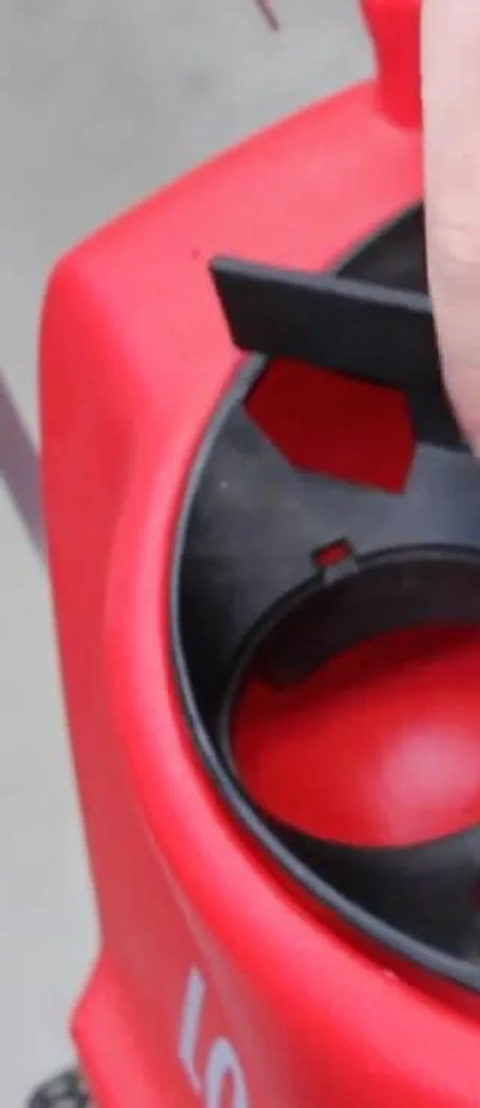 Remove the plastic feed wheel from the ball machine.