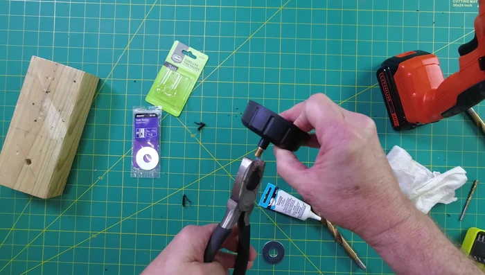 Secure the valve and washer by screwing on the plastic piece from inside the container.