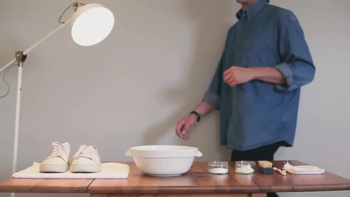 Fill a bowl with warm water and add detergent or washing powder.