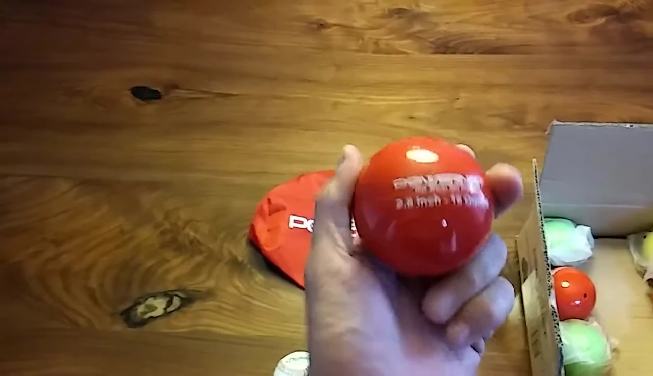 Close-up shot showing the texture and material of the weighted hitting balls.