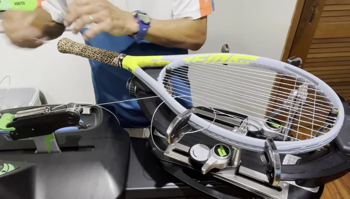 Free up the string clamp on the long side. Weave and tension the remaining crosses.