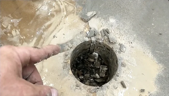 Install sleeve and concrete: Place a sleeve into the drilled hole, followed by additional concrete to secure it.