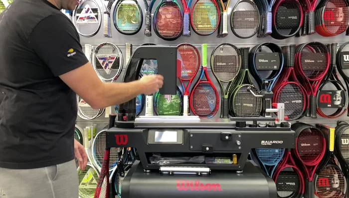 Align the racket and attach the top piece over the handle, tightening the knob to secure.