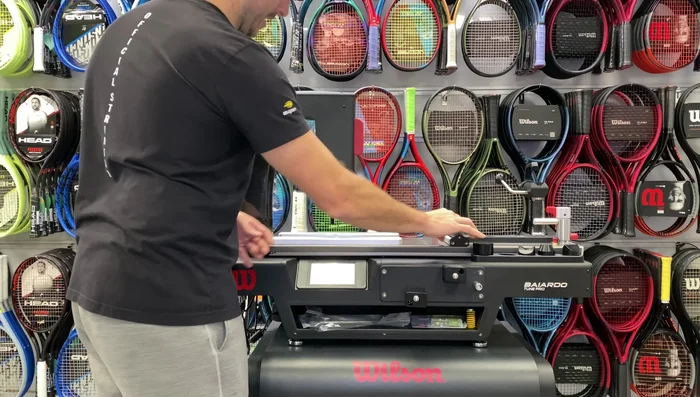 Align the racket and attach the top piece over the handle, tightening the knob to secure.