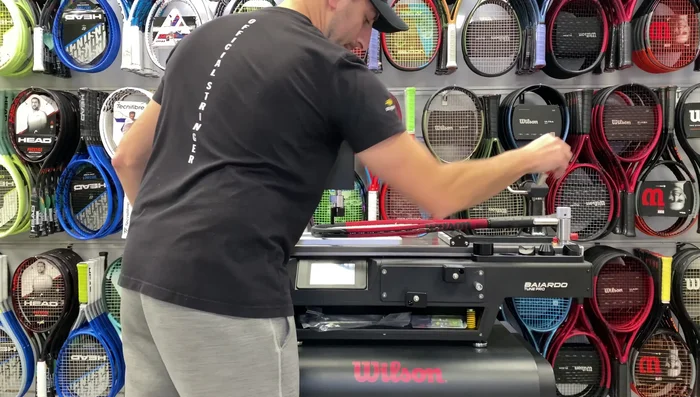 Align the racket and attach the top piece over the handle, tightening the knob to secure.