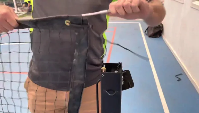 Grab the cable and attach it to the little wheel guide on the winder mechanism.