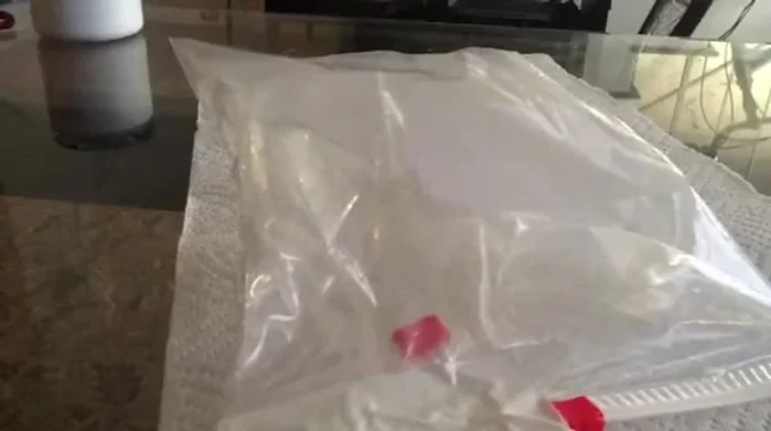 Press the inflated bag firmly against the car door to apply pressure to the lock mechanism.