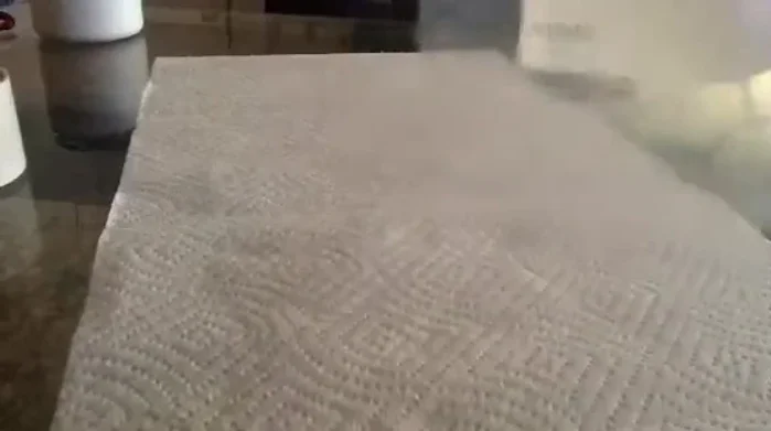 Create a lip around the opening of the bag by folding it over. This allows for better adhesion to the car door.