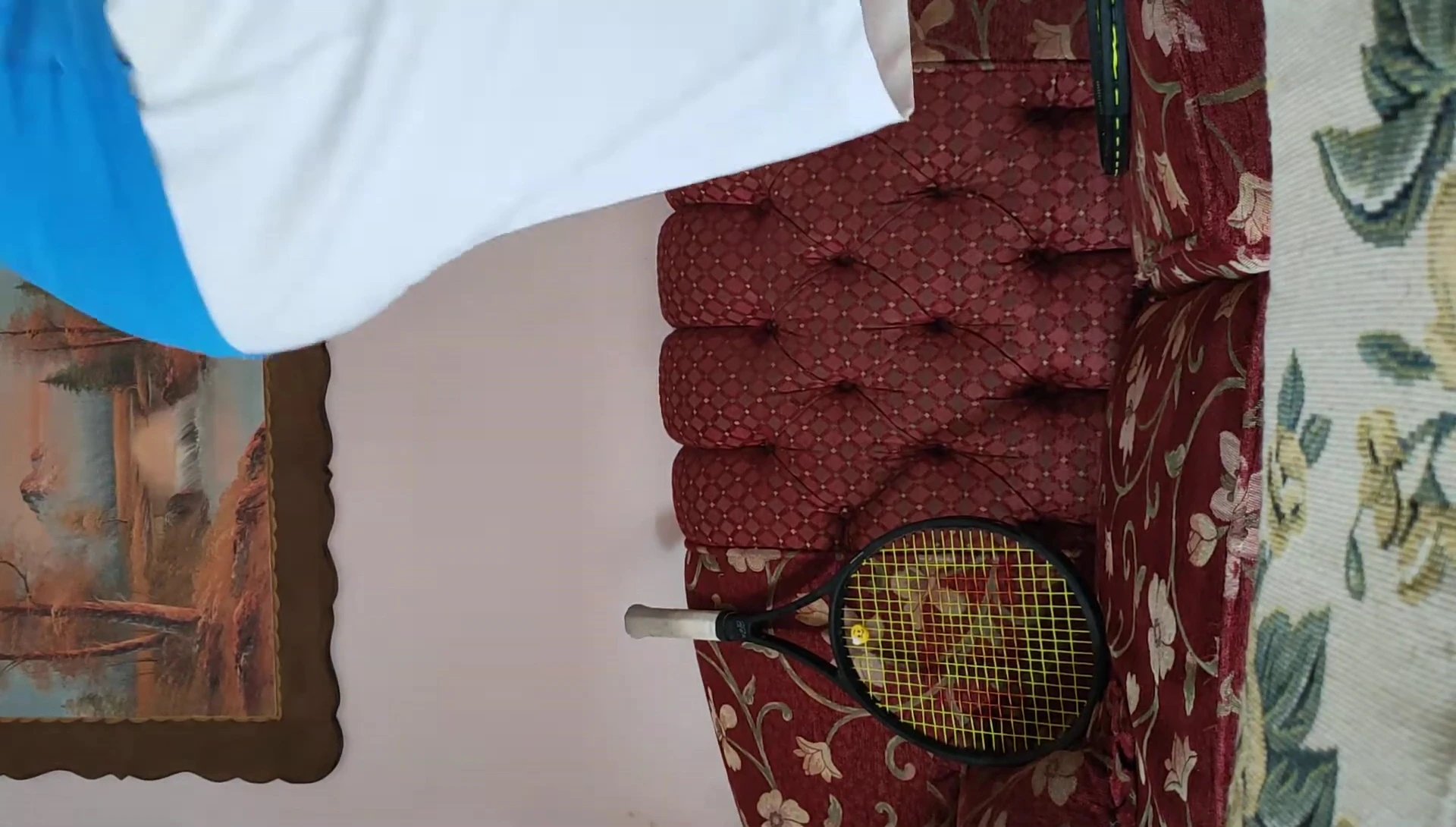 The speaker holding Wilson Pro Sensation overgrips.