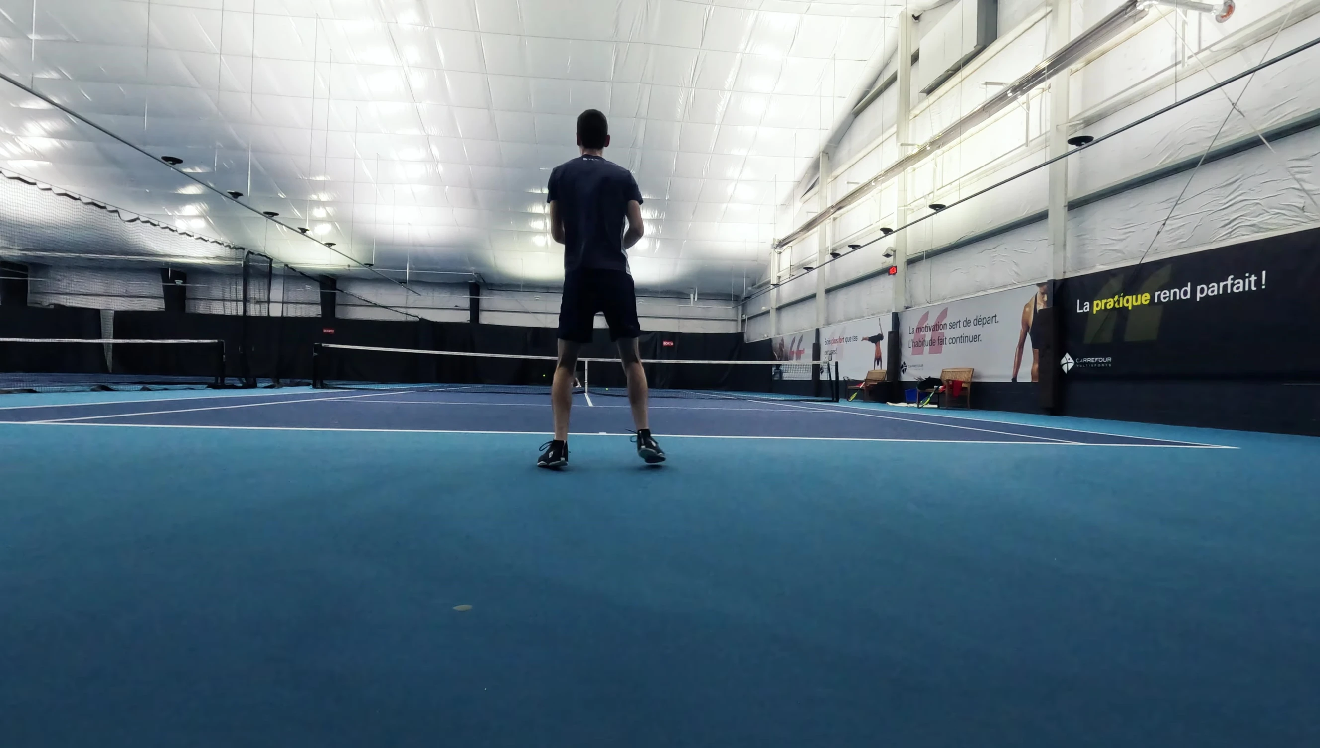 Action shot of the reviewer hitting a tennis ball with the Yonex Ezone 98 2025.