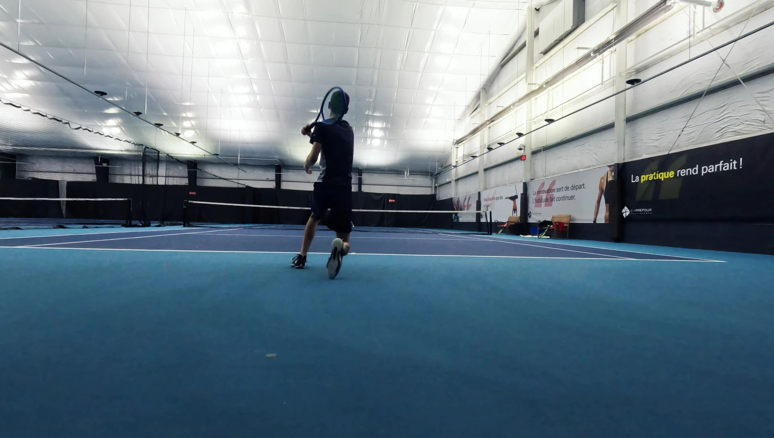 Action shot focusing on the reviewer's serve.