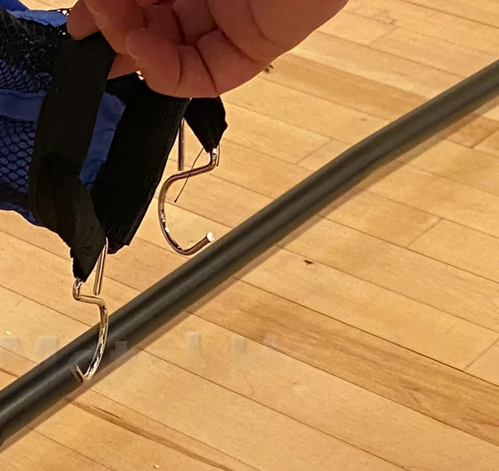 Add the metal hooks to the velcro straps on the ball chute.