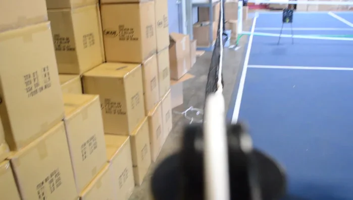 Run the cable to the other side of the net. The other loop goes around the pin on the crank.