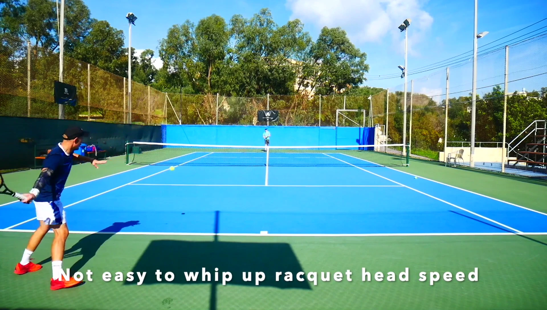 The reviewer holding the racquet and smiling