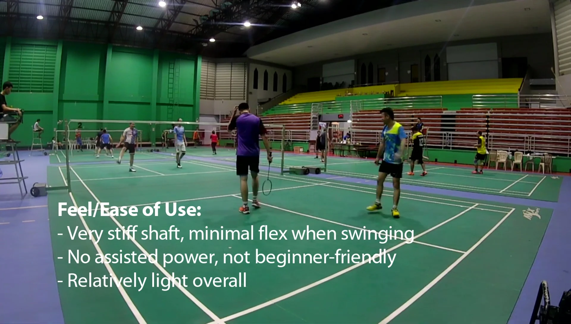 The reviewer demonstrating a swing, highlighting the stiffness of the racquet.