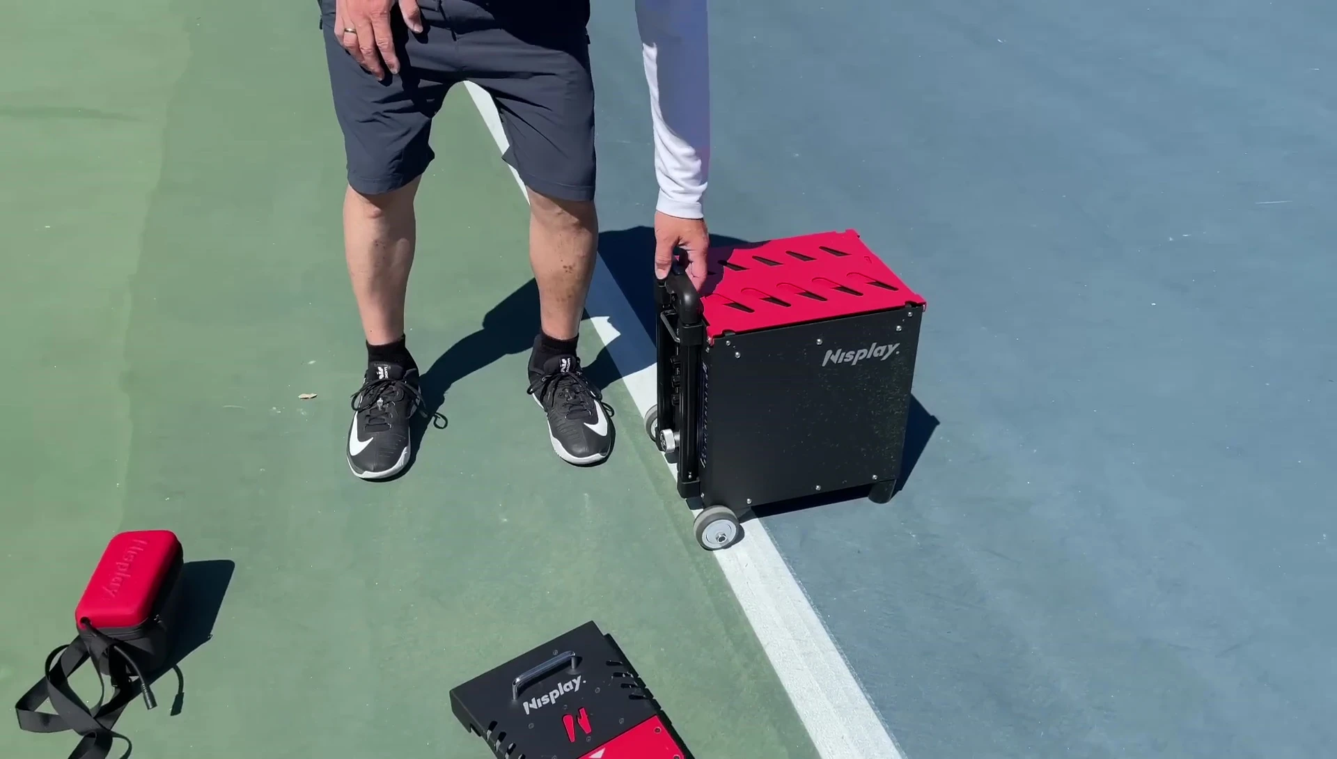 Close-up of the Nisplay portable tennis ball machine.