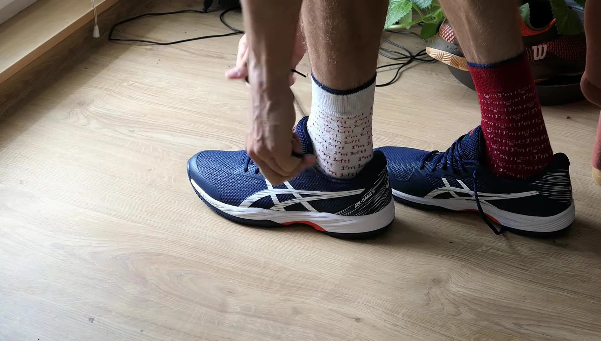 The reviewer holding up the ASICS GEL-GAME 9.